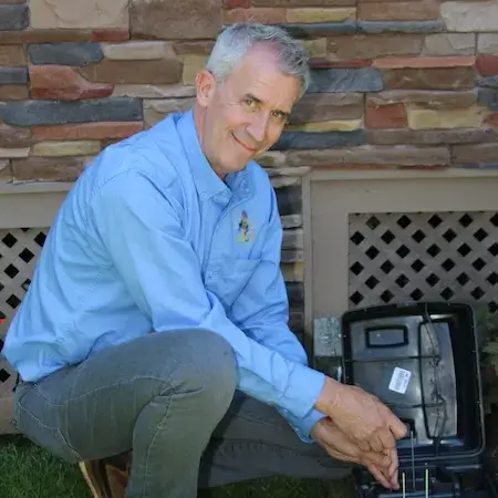 Rodent bait box placed along a foundation wall